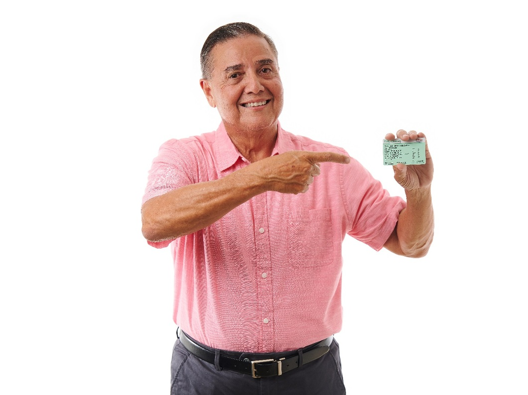 Older man with Te paga card in hand