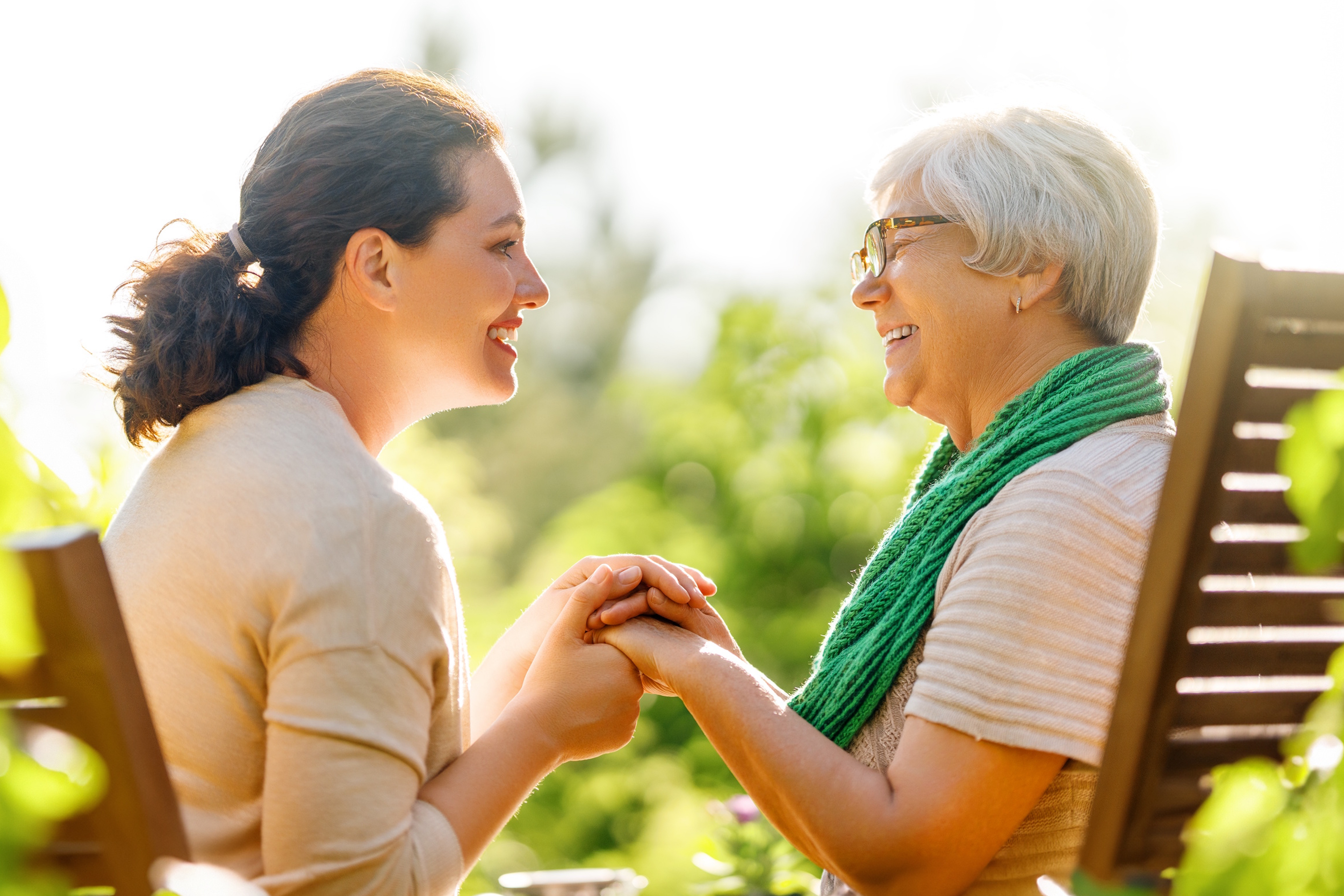 Couple hugging outdoors and smiling.
