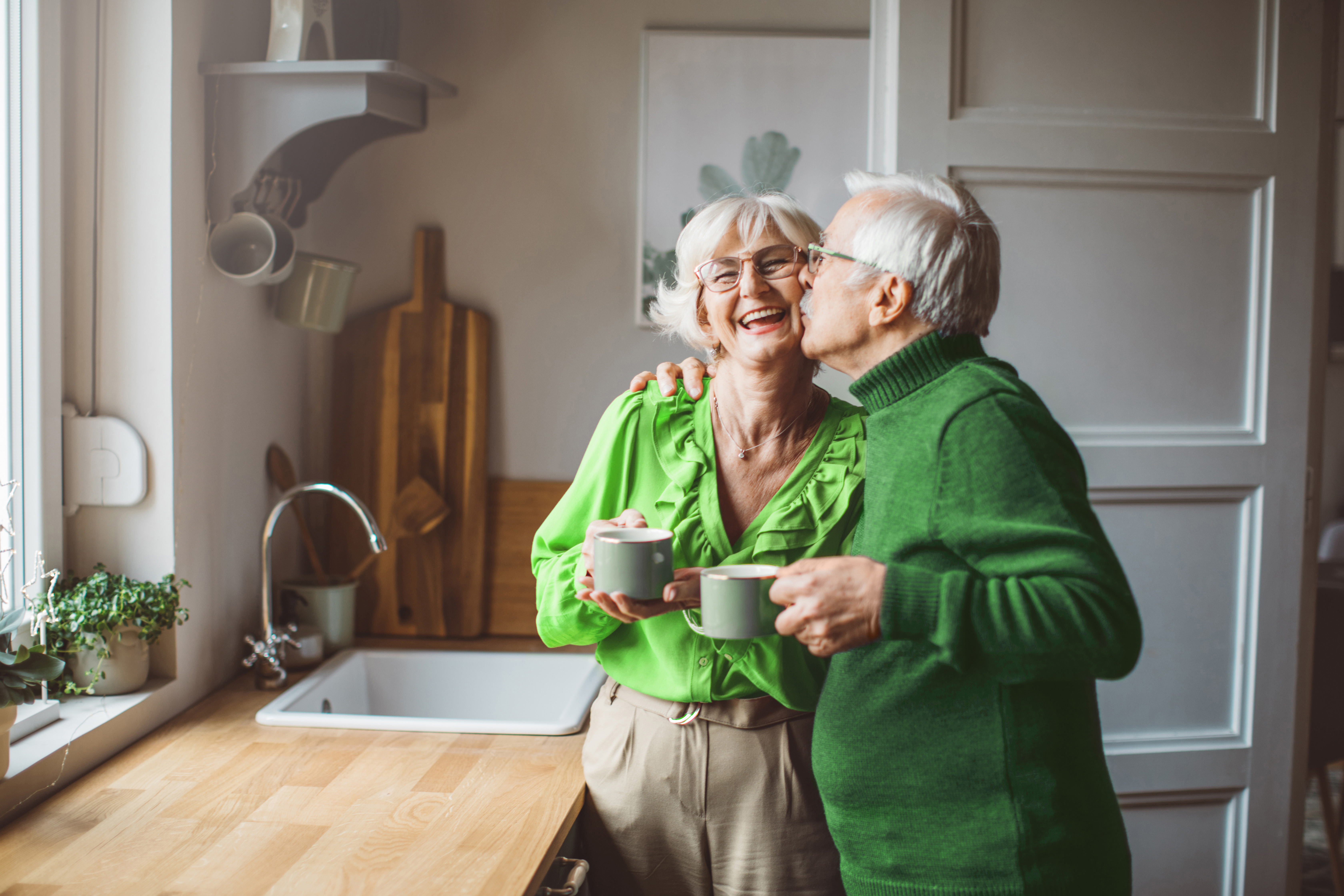 Older couple dancing and smiling.