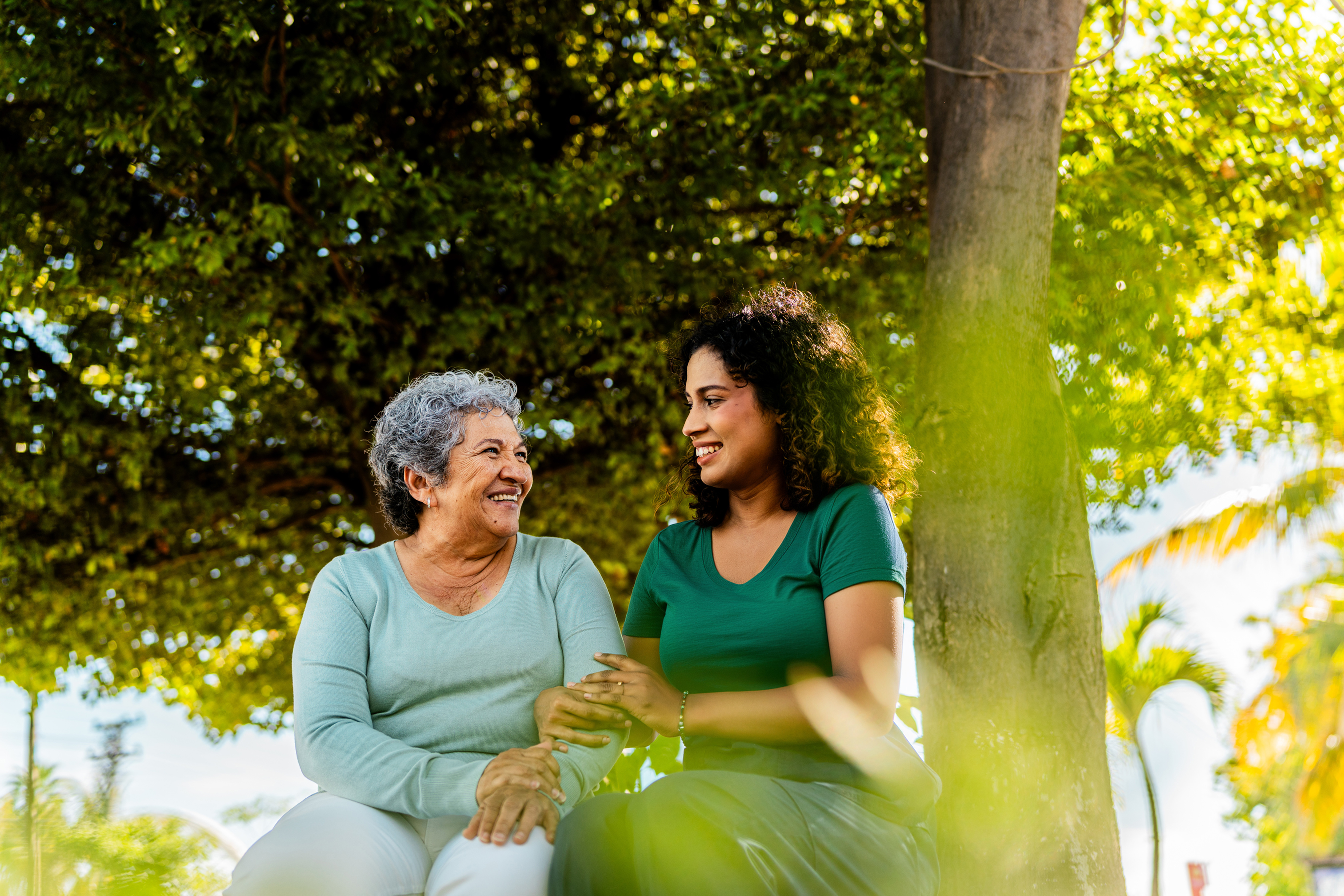 Older couple smiling and looking at each other, enjoying nature.